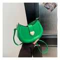 Vibrant lime green crescent saddle bag with golden heart buckle and slim leather strap - Green