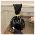 Vintage black pleated bucket handbag with unique gold sculptural pebble metal ornament - Black