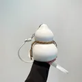 White leather gourd-shaped shoulder bag with decorative woven cord and silver zipper - White