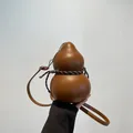Unique gourd-shaped brown leather crossbody bag for women with woven drawstring detail - Brown