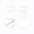 Macro shot of silver heart spade charm pendants with LOVE engraving for jewelry making - Antique Silver