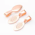 Macro detail of leaf-shaped rose gold plated jewelry pendant bails with grid patterns - Rose Gold