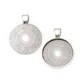 Macro shot of 25mm vintage silver pendant trays with intricate starburst engravings - Antique Silver
