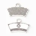 Vintage zinc alloy nurse hat pendants showing front cross detail and textured back - Antique Silver