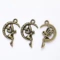 Macro view of antique bronze moon and fairy charms for DIY jewelry making and crafts - Antique Bronze