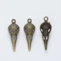 Three gothic raven skull charms in vintage bronze alloy with ornate floral carvings - Antique Bronze