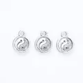 Close-up of three vintage silver Tai Chi Yin Yang alloy pendants for DIY jewelry making - Antique Silver