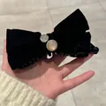 Détail de la pince banane en velours noir à double nœud avec perle et strass - Nœud en Velours avec Strass
