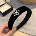 Elegant black velvet headband featuring a silver beaded flower with a sparkling crystal center - Flower / Black