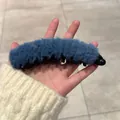 Detail of blue plush banana hair clip with teeth for secure high ponytail styling - Plush Blue