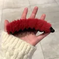 Detail showing plush red faux fur banana hair clip with internal black gripping teeth - Plush Rose Red