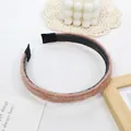 Detail of pink brown plush headband with black non-slip teeth on white textured background - Pink