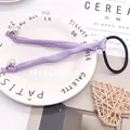 Elegant purple satin hair scrunchie with large white pearls and elastic band accessory - Lavender