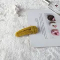 Bright yellow faux fur plush hair clip with a soft texture for elegant autumn styling - Turmeric