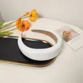 Close-up of padded white PU leather headband with brown non-slip velvet lining - White