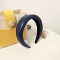 Detail of a thick navy blue PU leather headband on a desk with aesthetic card - Navy Blue