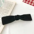 Close-up of elegant black velvet bow hair clip with vintage spring clip detail - Black Small Banana Clip Style