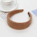 Detailed view of brown knit wide headband featuring a soft mohair texture and handmade label - Brown