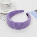 Detail view of purple knit headband with soft plush texture and premium black inner lining - Purple