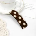 Detail of vintage brown polka dot fabric hair clip on an elegant decorative background - White Dots Brown Clip
