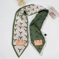 Detail of French bow silk scarf featuring geometric star patterns and handbag illustration - Y-Pattern Green Base