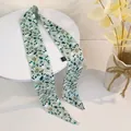 Detail of mint green floral silk hair ribbon with delicate white flower patterns - Dark Green