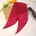 Close-up of rose red satin silk scarf headband with pointed ends on white surface - Red
