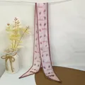 Detail of light pink chiffon scarf featuring bear and strawberry patterns and BEAR text - Pink Strawberry
