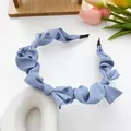 Light blue pleated satin headband with twisted bow design on elegant background - Light Blue
