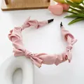 Pale pink satin headband featuring delicate pleats and multiple bow accents for girls - Flesh Pink