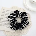 Stylish zebra print oversized scrunchie hair tie on elegant vintage lace and book background - Zebra Black Scrunchie