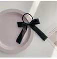 Elegant black satin bow hair tie with long ribbons for a minimalist feminine hairstyle - Black