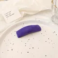 Elegant purple velvet sponge hair clip displayed on a minimalist white ceramic plate - Purple