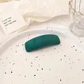 Minimalist dark green velvet rectangular hair clip displayed on a ceramic tray - Green