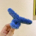 Close-up of a blue plush shark hair claw clip with soft faux fur and metal spring detail - Blue