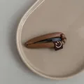 Brown PU leather teardrop hair clip with a cute smiley face tag on a ceramic tray - Dark Coffee
