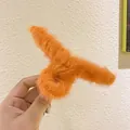 Detailed close-up of a large orange plush hair claw clip with soft fluffy texture - Orange