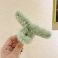 Close-up of soft light green plush hair claw clip showing fluffy faux fur texture - Grass Green