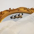 Wavy black and white checkerboard hair clip with gold metal base on mirror - Checkerboard Curved Style