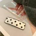 Chic rectangular hair clip featuring classic black and white polka dots on a glossy finish - Polka Dot / Rectangle / Black and White