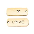 Detailed view of vintage gold alloy LOVE pendants with heart-shaped cutouts for DIY jewelry - Antique Gold