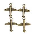 Set de cuatro dijes de avión vintage de aleación de zinc para creación de joyas DIY - Bronce