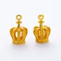 Gedetailleerde macro-opname van twee gouden kroonbedels met reliëfstippen voor DIY-sieraden - Goud