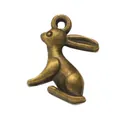 Macro detail of vintage bronze rabbit charm with alloy texture and hanging loop - Antique Bronze