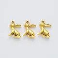 Three vintage gold alloy bunny rabbit charms for DIY jewelry making on white background - Antique Gold