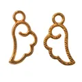Detail of wing-shaped jewelry charms in polished gold and twisted rope texture for DIY making - Gold