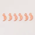 Detailed view of six rose gold crescent moon charms with vintage smiling face engravings - Rose Gold