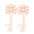 Macro detail of rose gold vintage key bottle opener with intricate floral filigree - Rose Gold