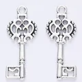 Pair of antique silver alloy key charms with intricate openwork patterns for DIY jewelry - Antique Silver