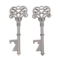 Macro detail of two vintage alloy key bottle openers with intricate floral carvings - Gun Black